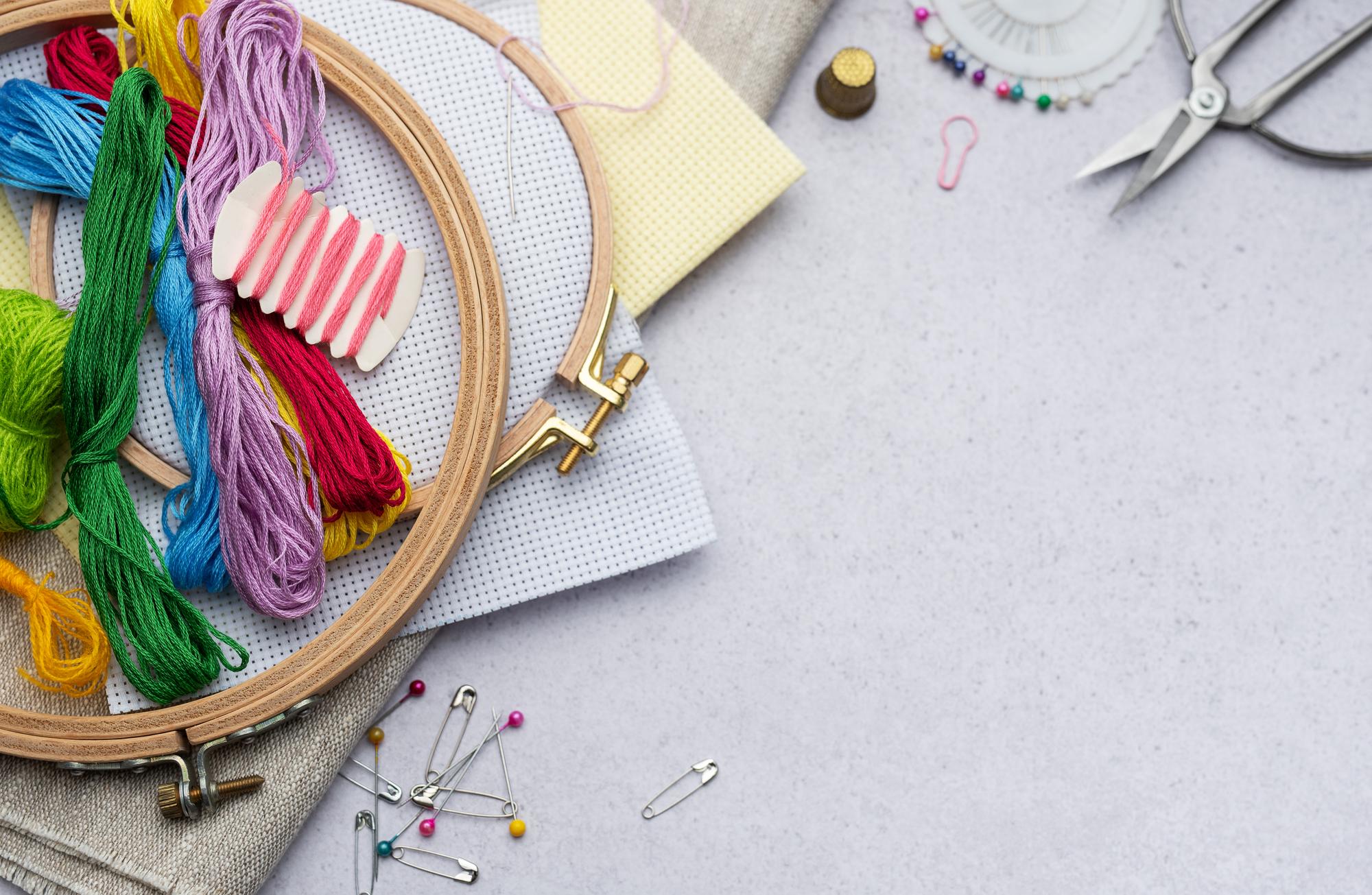 artisan arranging embroidery threads on a table